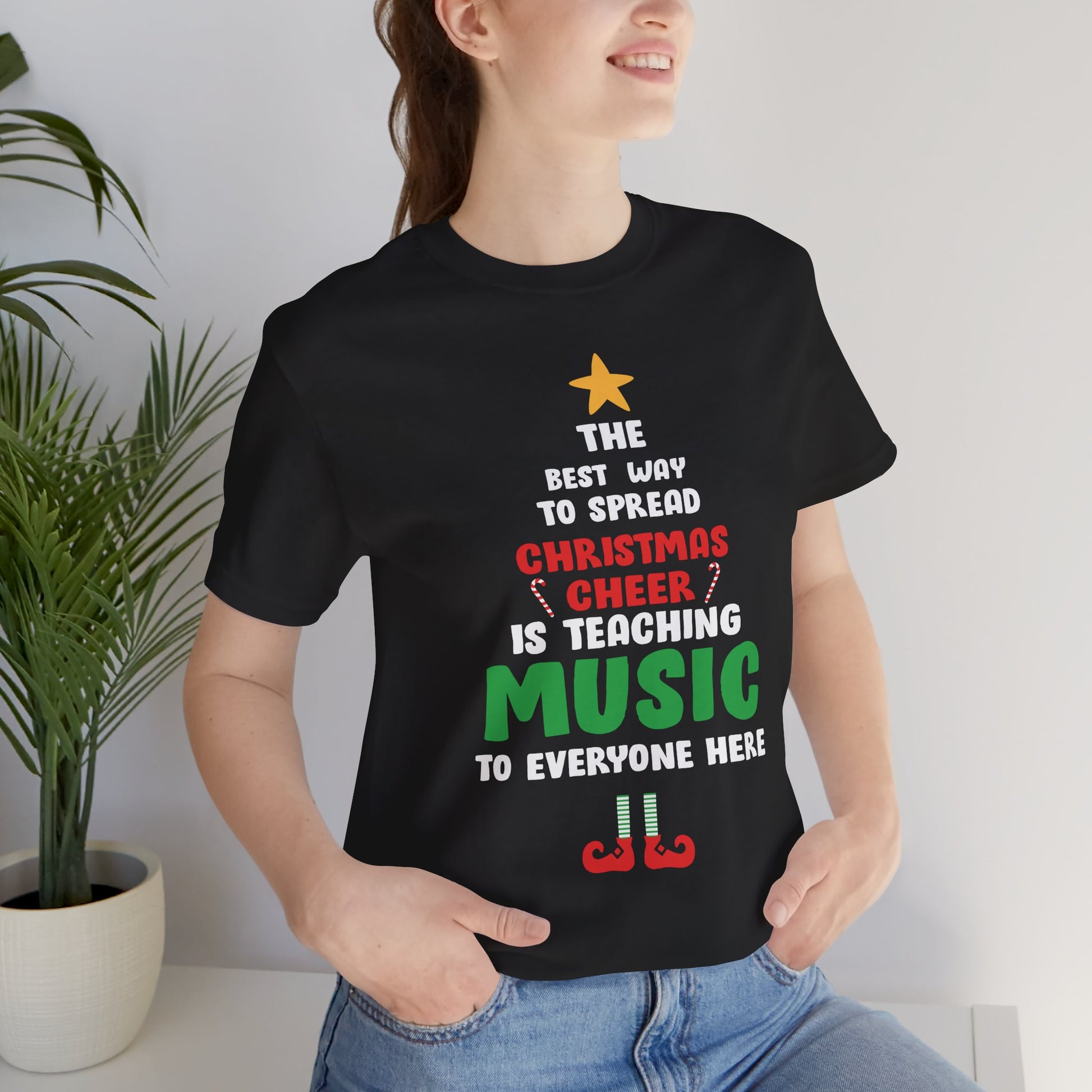 Christmas Cheer is Teaching Music Graphic Cotton T-Shirt - Festive Short Sleeve Tee for Music Teachers | Unique Design, Comfortable Fit, Premium Quality Printify