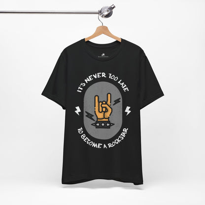 It's Never Too Late to Become a Rockstar Graphic Cotton T-Shirt - Motivational Short Sleeve Tee for Aspiring Musicians | Unique Design, Comfortable Fit, Premium Quality Printify