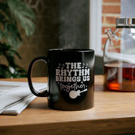 "The Rhythm Brings Us Together" Black Ceramic Mug – Perfect for Coffee, Tea & Hot Chocolate Lovers Printify